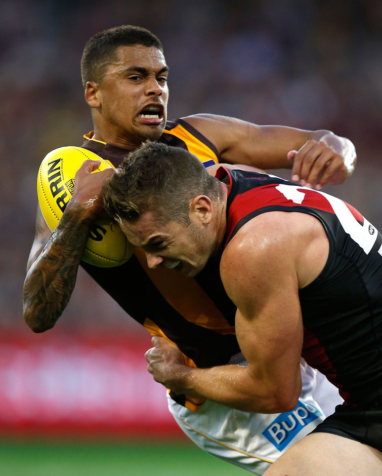 AFL 2015 Rd 02 - Essendon v Hawthorn Bradley Hill of the Hawks is tackled by Patrick Ambrose of the Bombers during the 2015 AFL Round 02 match between the Essendon Bombers and the Hawthorn Hawks at the MCG, Melbourne on April 12, 2015. (Photo: Michael Willson/AFL Media)
